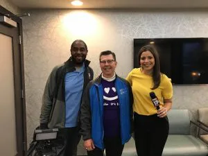 Dr. Bradley Dykstra Posing with news and media at free dental day in Grand Rapids